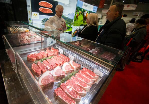(200301) -- TORONTO, March 1, 2020 -- People visit a meat vendor during the 2020 Restaurants Canada Show in Toronto, Canada, March 1, 2020. As the largest foodservice and hospitality event in Canada, this annual three-day event kicked off here on Sunday with the latest innovations in food, beverage products and equipments. (Photo by Xinhua) CANADA-TORONTO-RESTAURANTS CANADA SHOW ZouxZheng 