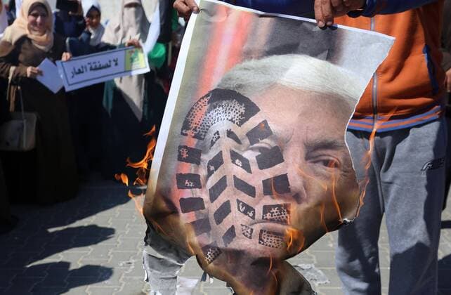 March 3, 2020, Khan Younis, Gaza Strip, Palestinian Territory: Palestinian protesters burn posters depicting the faces of US President Donald Trump and Israeli Prime Minister Benjamin Netantyahu during a protest against US President Donald Trump s Century Deal expected peace plan , in Khan Younis in the of Gaza strip, on March 3, 2020 Khan Younis Palestinian Territory - ZUMAap3_ 20200303_zaf_ap3_053 Copyright: xAshrafxAmrax