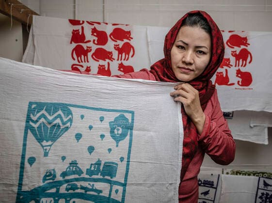 March 6, 2020, Albuquerque, NM, USA: March 6, 2020, .Kei & Molly Textiles, LLC hand printed original designs is a local company is a textile company that produces products from kitchen towels to shirts. They also employ refugee women who create textiles. Pictured is Tahira Akbari(Cq) of Afghanistan. She works in the print shop..Albuquerque, New Mexico. Albuquerque Journal Albuquerque USA - ZUMAab1_ 20200306_zaf_ab1_006 Copyright: xRobertoxE.xRosalesx