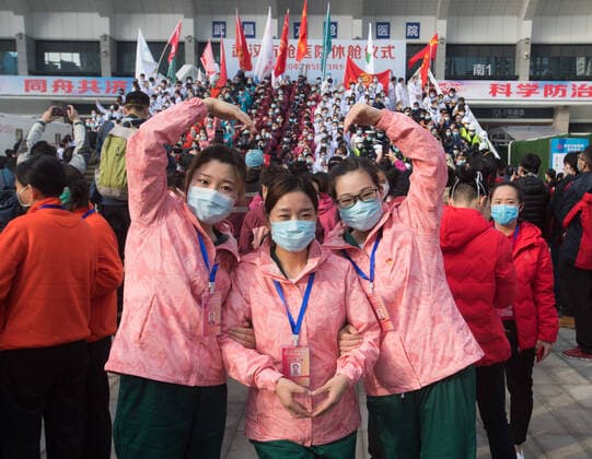 (200310) -- WUHAN, March 10, 2020 -- Medical workers pose for photo as they celebrate after the closure of a temporary hospital in Wuchang District of Wuhan, central China s Hubei Province, March 10, 2020. The last two temporary hospitals in Wuhan, the epicenter of the coronavirus outbreak in central China s Hubei Province, were shut down Tuesday, marking the closure of all 16 temporary hospitals in the city. ) CHINA-WUHAN-TEMPORARY HOSPITALS-CLOSURE (CN) XiaoxYijiu 