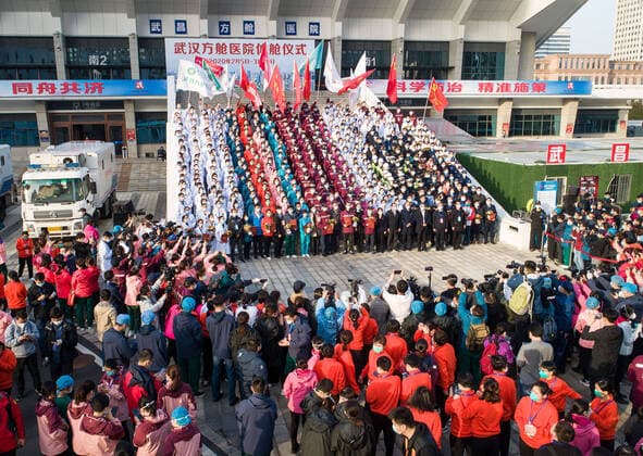 (200310) -- WUHAN, March 10, 2020 -- Aerial photo taken on March 10, 2020 shows medical workers celebrating after the closure of a temporary hospital in Wuchang District of Wuhan, central China s Hubei Province. The last two temporary hospitals in Wuhan, the epicenter of the coronavirus outbreak in central China s Hubei Province, were shut down Tuesday, marking the closure of all 16 temporary hospitals in the city. ) CHINA-WUHAN-TEMPORARY HOSPITALS-CLOSURE (CN) XiaoxYijiu 