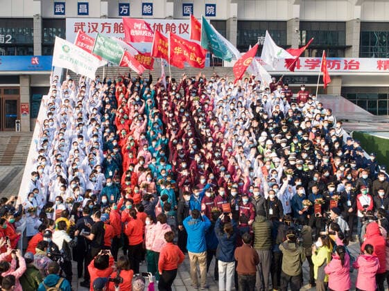 (200310) -- WUHAN, March 10, 2020 -- Aerial photo taken on March 10, 2020 shows medical workers celebrating after the closure of a temporary hospital in Wuchang District of Wuhan, central China s Hubei Province. The last two temporary hospitals in Wuhan, the epicenter of the coronavirus outbreak in central China s Hubei Province, were shut down Tuesday, marking the closure of all 16 temporary hospitals in the city. ) CHINA-WUHAN-TEMPORARY HOSPITALS-CLOSURE (CN) XiaoxYijiu 