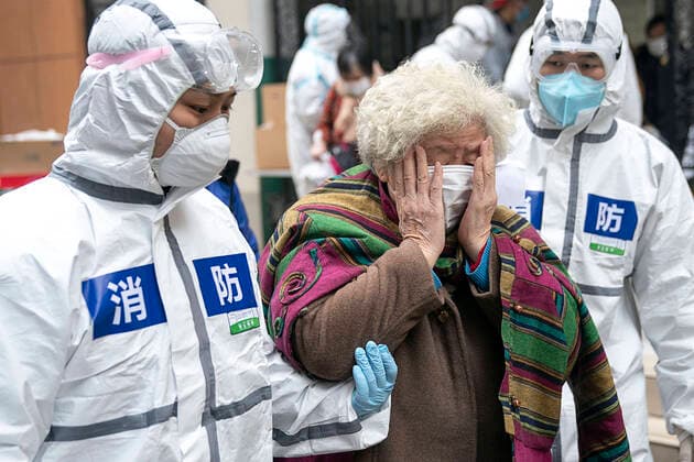 (200310) -- WUHAN, March 10, 2020 -- A cured coronavirus patient sheds tears as she walks out of a rehabilitation center after a 14-day quarantine for medical observation in Wuhan, central China s Hubei Province, March 10, 2020. A total of 143 cured coronavirus patients who were discharged from hospital finished their 14-day quarantine for medical observation on Tuesday at the rehabilitation center based in Wuhan Vocational College of Software and Engineering. They would be sent directly to their communities and return home accompanied by community staff. Wuhan, the epicenter of the novel coronavirus outbreak, has required COVID-19 patients who were discharged from hospital to go on a 14-day quarantine at designated places for medical observation. ) CHINA-WUHAN-COVID-19-CURED PATIENTS-MEDICAL OBSERVATION(CN) XiongxQi 