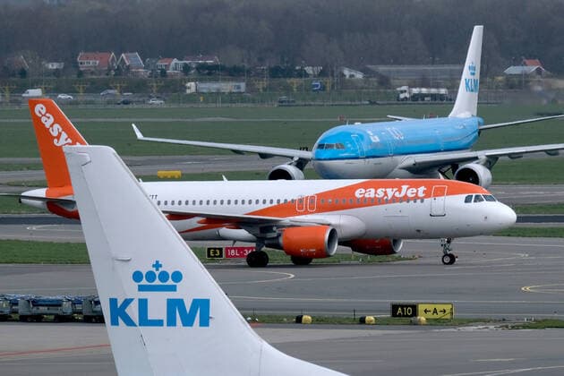 An aircraft operated by British low cost airline Easyjet drives between airplanes operated by KLM Royal Dutch Airlines in Amsterdam Airport Schiphol on March 9, 2020 in Schiphol, Netherlands.  (124139553)