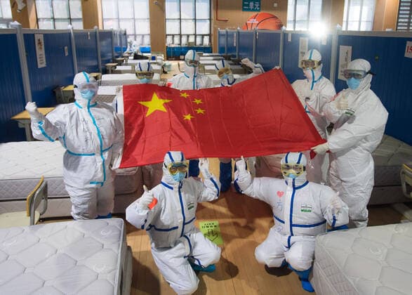 (200311) -- WUHAN, March 11, 2020 -- Medical workers pose for photos after seeing cured patients off at the Wuchang temporary hospital in Wuhan, central China s Hubei Province, March 10, 2020. The last two temporary hospitals in Wuhan, the epicenter of the coronavirus outbreak in central China s Hubei Province, were shut down Tuesday, marking the closure of all 16 temporary hospitals in the city. ) CHINA-WUHAN-TEMPORARY HOSPITALS-CLOSURE (CN) XiaoxYijiu 