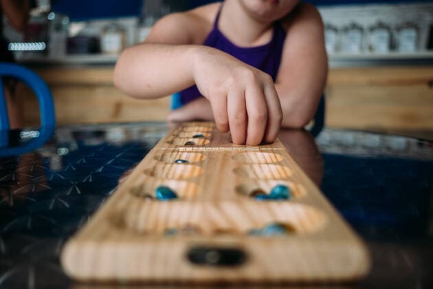 straight on view of child playing mandala at a table Denver, CO, United States ,model released, Symbolfoto CR_JEMI200115E-277582-01