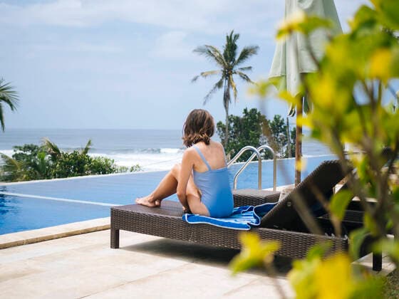 Woman sunbathing lounge chair poolside Denpasar, Bali, Indonesia ,model released, Symbolfoto CR_KOTRIN200115H-238108-01