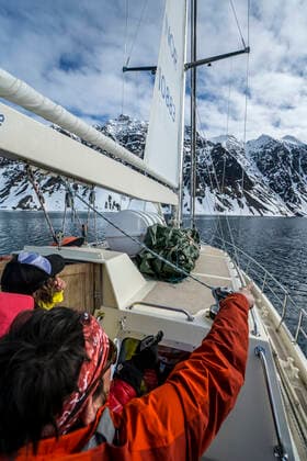 Friends on ski trip on sailboat going towards Jan Mayen Olonkin City, Jan Mayen, Svalbard and Jan Mayen ,model released, Symbolfoto ,editorial use only CR_FGUQ200120B-291448-01
