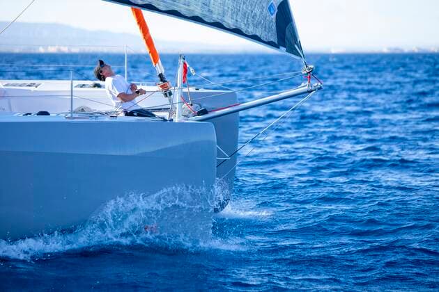 A sailor on the foredeck of a catamaran checking on the rigging Canet-en-Roussillon, Occitanie, France ,editorial use only CR_CHLA200203-250919-01