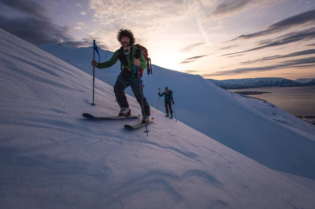 Man and woman backcountry skiing in Iceland with water behind Dalvik, Iceland ,model released, Symbolfoto CR_BRDO200210D-286490-01