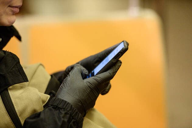 March 17, 2020, New York Manhattan, USA: Commuter using surgical gloves in the subway . New York City completely empty during the coronavirus outbreak. 03 17 20. New York Manhattan Q Train 2AV. . New York Manhattan USA - ZUMAs252 20200317_znp_s252_002 Copyright: xMarcusxSantosx