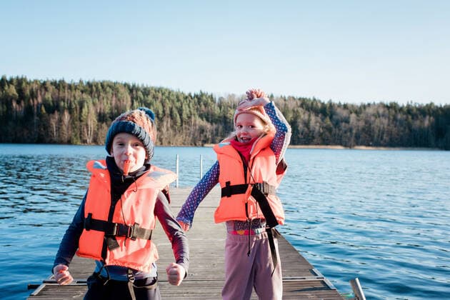 brother and sister playing at the beach wearing life jackets in winter NorrtoÂ¤lje, Stockholm County, Sweden ,model released, Symbolfoto CR_RABE200224-308738-01