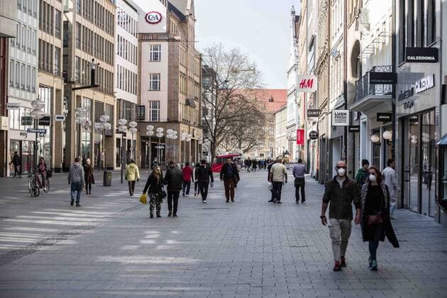 March 19, 2020, Munich, Bavaria, Germany: Two tourists wear face masks in the relatively empty streets in the city center of Munich, Germany. Ordinarily, these streets are filled with tens of thousands from around the world. As a response to the increasingly dire Coronavirus (Sars CoV 2, Covid 19), the state of Bavaria has instituted measures that restrict the operations of various types of businesses that has led to the city center, once filled with tens of thousands of tourists and residents, to become a virtual ghost town, with limited numbers of people in sight. Munich Germany - ZUMAb160 20200319_zbp_b160_028 Copyright: xSachellexBabbarx