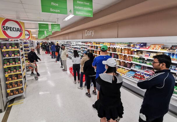 COLES EPPING TOILET PAPER QUEUE, People queueing for a delivery of toilet paper, paper towel and pasta at Coles Supermarket, Epping in Sydney, Friday, March 20, 2020. Supermarkets have been struggling to keep up with demand for products such as toilet paper in recent days, as panic buying as a result of the Covid-19 pandemic has resulted in people purchasing far more than usual. Supermarkets have put in place limits on the quantity people can purchase of many everyday items. ( NO ARCHIVING, EDITORIAL USE ONLY, NO USE IN BOOKS WITHOUT CONSENT SYDNEY NSW AUSTRALIA  Copyright: xJAMESxGOURLEYx 20200320001458259312
