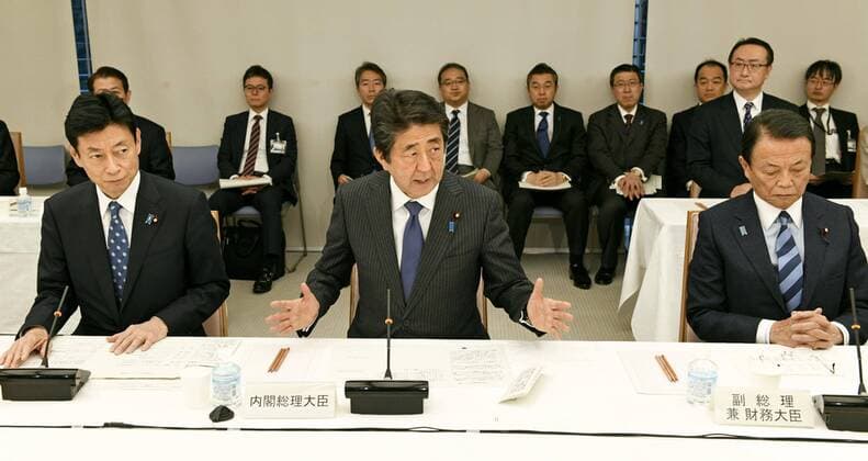 New coronavirus Japanese Prime Minister Shinzo Abe (C) speaks during a meeting on the coronavirus crisis on March 20, 2020, in Tokyo. 
