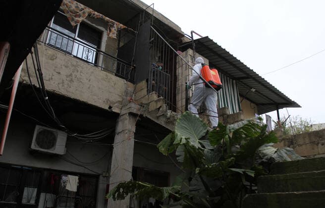 (200320) -- TRIPOLI, March 20, 2020 (Xinhua) -- A volunteer disinfects houses as a precautionary measure against the COVID-19 epidemic at a community in Tripoli, Lebanon, March 20, 2020. Lebanon s Health Ministry announced on Friday that the number of COVID-19 cases in the country has increased to 163, the National News Agency reported. (Photo by Khalid Xinhua) LEBANON-TRIPOLI-COVID-19-VOLUNTEER 