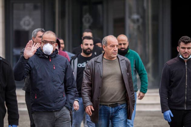 March 20, 2020, Bethlehem, West Bank: Released Palestinians from quarantine at Paradise Hotel salutes the medical staff & policemen after the end of 14 days quarantine. Bethlehem West Bank - ZUMAb133 20200320_zap_b133_047 Copyright: xMustafaxBaderx