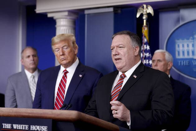 Mike Pompeo, U.S. secretary of state, speaks as U.S. President Donald Trump, second left, listens during a Coronavirus Task Force news conference in the briefing room of the White House in Washington, DC on Friday, March 20, 2020. Americans will have to practice social distancing for at least several more weeks to mitigate U.S. cases of Covid-19, Anthony S. Fauci of the National Institutes of Health said today.  WAX20200320203 ALxDRAGO