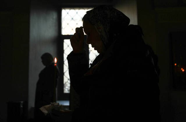 MOSCOW, RUSSIA - MARCH 20, 2020: A believer during an evening service at the Vysokopetrovsky Monastery. Starting from March 18, monks conduct a religious procession and spray holy water after the evening service at the monastery amid the coronavirus pandemic. Sergei Bobylev TASS  TS0D2EDB