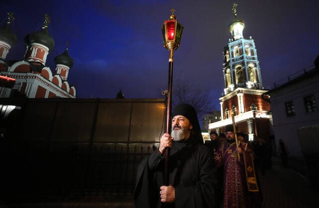 MOSCOW, RUSSIA - MARCH 20, 2020: Priests during a religious procession at the Vysokopetrovsky Monastery. Starting from March 18, monks conduct a religious procession and spray holy water after the evening service at the monastery amid the coronavirus pandemic. Sergei Bobylev TASS  TS0D2EDE