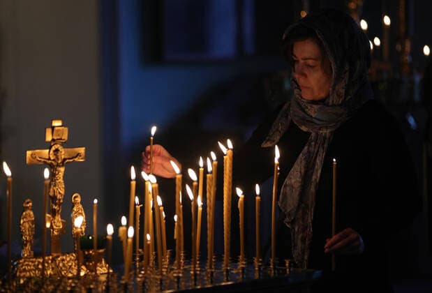 MOSCOW, RUSSIA - MARCH 20, 2020: A believer during an evening service at the Vysokopetrovsky Monastery. Starting from March 18, monks conduct a religious procession and spray holy water after the evening service at the monastery amid the coronavirus pandemic. Sergei Bobylev TASS  TS0D2EEB