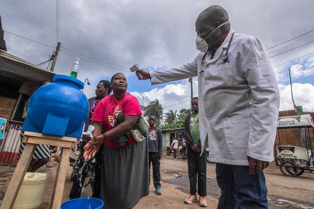 March 20, 2020, Nairobi, Kenya, Africa: A local Doctor, Dr Fredrick Ochenge perfoms a temperature check up for the locals around Kibera Slums in Kenya. Nairobi Africa - ZUMAd156 20200320_zip_d156_008 Copyright: xDonwilsonxOdhiambox
