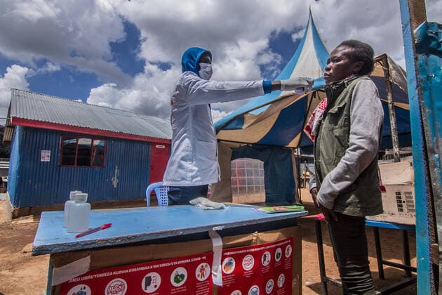 March 20, 2020, Nairobi, Kenya, Africa: A local health official checks the temperature of a local patient as part of corona virus testing procedure in Kibera. Nairobi Africa - ZUMAd156 20200320_zip_d156_011 Copyright: xDonwilsonxOdhiambox