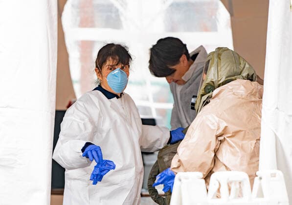 March 20, 2020, Somerville Hospital, Somerville, Massachusetts, USA: Health workers at a drive-thru coronavirus disease testing site at Somerville Hospital in Somerville, Massachusetts.  (124584559)