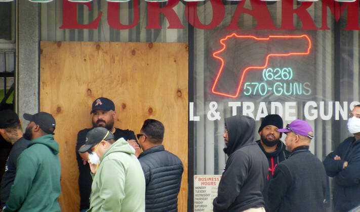 March 20, 2020, Alhambra, CALIFORNIA, UNITED STATES OF AMERICA: People wait in line out side a Gun Store in the City of Alhambra on Friday 20 March, 2020.. Gun stores in the US are reporting a surge in sales of firearms as coronavirus fears trigger personal safety concerns. . Alhambra UNITED STATES OF AMERICA - ZUMAa60_ 20200320_zaf_a60_003 Copyright: xArmandoxArorizox