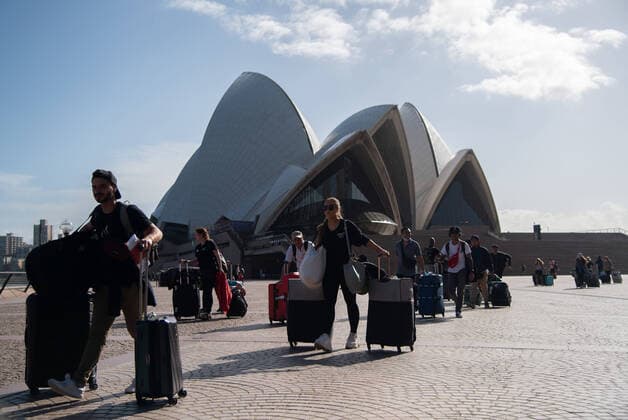 CORONAVIRUS AUSTRALIA, Crew members of the Cruise Ship Ovation of the Seas walking past the Sydney Opera House after disembarking from the ship, Sydney, Saturday, March 21, 2020. Sydney is seeing a dramatic reduction in people on the streets as people are asked to enact social distancing and self isolation in order to prevent the spread of Covid-19. ( NO ARCHIVING, EDITORIAL USE ONLY, NO USE IN BOOKS WITHOUT CONSENT SYDNEY NSW AUSTRALIA  Copyright: xJAMESxGOURLEYx 20200321001458536013