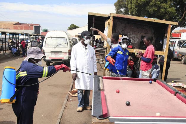 (200321) -- HARARE, March 21, 2020 (Xinhua) -- Health workers disinfect a public bus terminus in Harare, Zimbabwe, March 20, 2020. Zimbabwe on Friday reported its first confirmed case of COVID-19 after a male from Victoria Falls, who had traveled to the United Kingdom, was tested positive. (Photo by Shaun Jusa Xinhua) ZIMBABWE-HARARE-CORONAVIRUS-FIRST CASE 