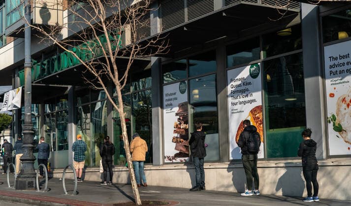 March 20, 2020, San Francisco, California, USA: Shoppers wait in line, with space between them, to avoid catching the coronavirus at the Whole Foods Grocery Market on Friday, March 20, 2020. Zuma San Francisco USA - ZUMAk13_ 20200320_zap_k13_001 Copyright: xPaulxKurodax