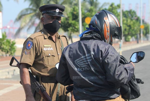 March 21, 2020, Colombo, Sri Lanka: Police check a motorcyclist in the empty street is seen after the authorities announced a weekend curfew in country as a preventive measure against the spread of the COVID-19 novel coronavirus, in Colombo March 21, 2020. Colombo Sri Lanka - ZUMAd152 20200321_znp_d152_001 Copyright: xPradeepxDambaragex