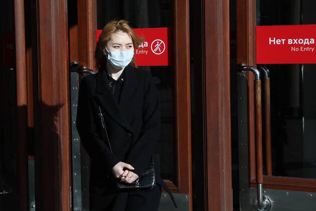 MOSCOW, RUSSIA - MARCH 21, 2020: A girl in a face mask walking out of a Moscow Metro station during the COVID-19 coronavirus pandemic. Alexander Shcherbak TASS  TS0D2F09