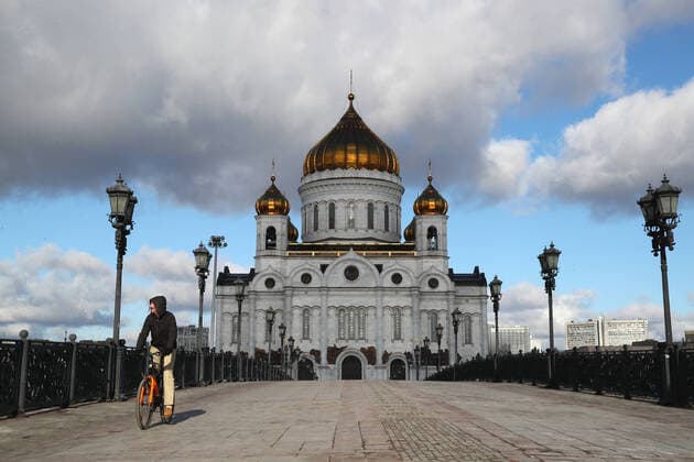 MOSCOW, RUSSIA - MARCH 21, 2020: A man riding a bicycle by the Cathedral of Christ the Savior. Alexander Shcherbak TASS  TS0D2F26