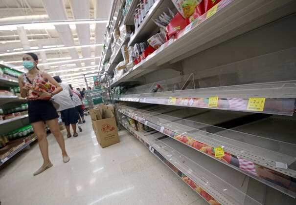 March 20, 2020, Bangkok, Thailand: People in Bangkok buy instant foods and consumer products next to empty shelves at supermarket in Bangkok on March 21, 2020. City Hall has ordered Bangkok shopping malls to close from Sunday until April 12 as it steps up the battle against the spread of the coronavirus. Bangkok Thailand - ZUMAu103 20200320_zia_u103_016 Copyright: xUrdeexImagex