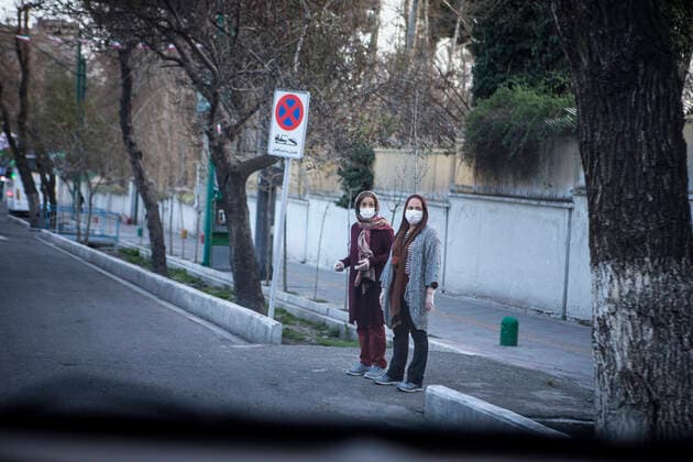 (200321) -- TEHRAN, March 21, 2020 -- Women wearing masks are seen at an empty street in Tehran, Iran, on March 20, 2020. The total number of confirmed COVID-19 cases in Iran edged toward 20,000 on Friday. (Photo by Xinhua) IRAN-TEHRAN-COVID-19-EMPTY STREETS AhmadxHalabisaz 
