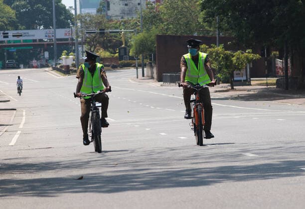 Sri Lanka: Empty street after curfew due to COVID-19 A Police officers rides a bicycles in the empty street is seen after the authorities announced a weekend curfew in the country as a preventive measure against the spread of the COVID-19 novel coronavirus, in Colombo March 21, 2020. Colombo Western Province Sri Lanka Copyright: SamanxAbesiriwardana