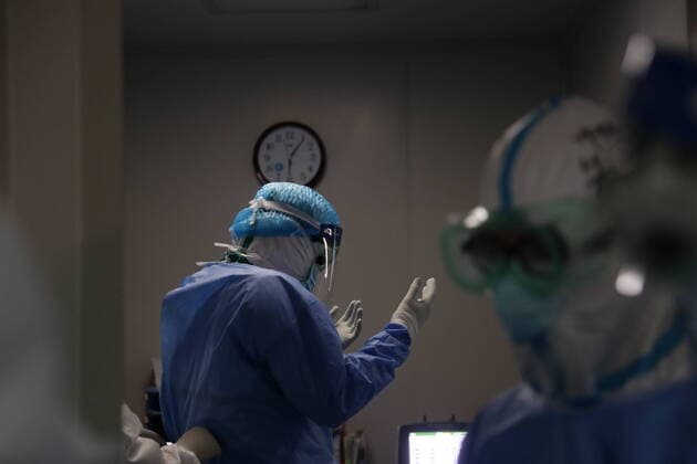 (200321) -- WUHAN, March 21, 2020 -- Chen Huaidong, a doctor from the Sir Run Run Shaw Hospital affiliated with the Zhejiang University School of Medicine, wears a protective suit before a surgery for a patient of COVID-19 in critical condition at a hospital in Wuhan, central China s Hubei Province, March 21, 2020. Doctors from Beijing, Jiangsu and other four different provinces have successfully completed the three-hour surgery on a male patient of COVID-19 in critical condition with joint efforts. (Photo by Xinhua) CHINA-HUBEI-WUHAN-COVID-19-SURGERY (CN) KexHao 