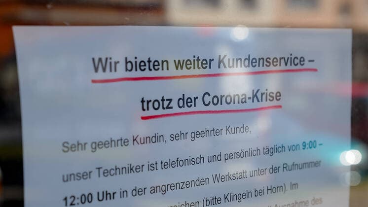 Zur Eindämmung des Coronavirus wurden Geschäftsschließungen angeordnet und werden Ausgangssperren diskutiert, das Foto zeigt ein Hinweisschild, Aushang im Fenster eines Geschäftes, Aufschrift: Wir bieten weiter Kundenserve trotz der Corona-krise, 21.03.2020, Bremen (Deutschland), News, Feature, Coronavirus Bremen