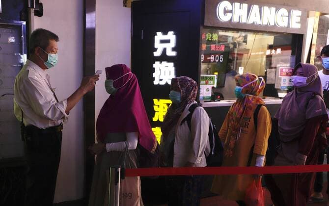 March 22, 2020, Hong Kong, CHINA: Muslim women queue up to receive thermo check at the local shopping arcade before entering the premise.Mar-22,2020 Hong Kong.ZUMA Hong Kong CHINA - ZUMAl137 20200322_zap_l137_003 Copyright: xLiauxChung-renx