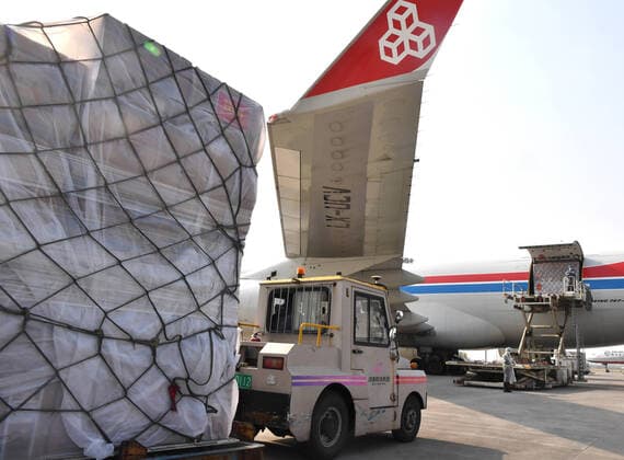 (200322) -- ZHENGZHOU, March 22, 2020 -- Staff load donated materials onto a cargo plane at Xinzheng International Airport in Zhengzhou, capital of central China s Henan Province, March 22, 2020. The first batch of medical supplies donated by China s Henan Province, including 500,000 surgical masks and 100,000 pairs of medical gloves, departed from Zhengzhou on Sunday for Luxembourg by direct airline along the Air Silk Road linking Luxembourg with Zhengzhou to help Luxembourg fight the COVID-19. ) CHINA-HENAN-COVID-19-LUXEMBOURG-DONATED MATERIALS-DEPARTURE (CN) LixJianan 
