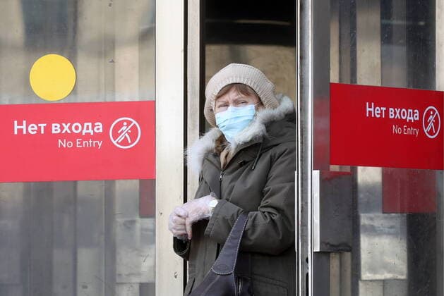 MOSCOW, RUSSIA - MARCH 22, 2020: A woman in a face mask walking out of a Moscow Metro station during the COVID-19 coronavirus pandemic. Vyacheslav Prokofyev TASS  TS0D3094