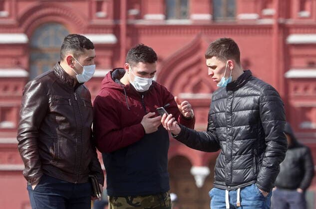 MOSCOW, RUSSIA - MARCH 22, 2020: People in face masks seen in Red Square during the COVID-19 coronavirus pandemic. Stanislav Krasilnikov TASS  TS0D309F