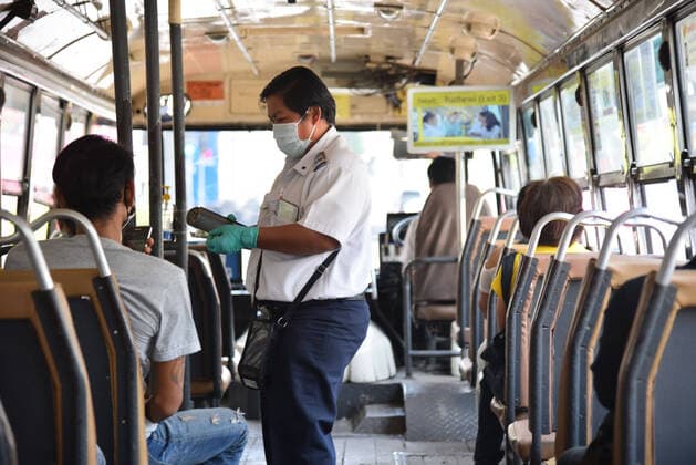 March 22, 2020, Bangkok, Thailand: A bus Cashier wearing a protective mask and gloves amid Coronavirus fears..Thailand s government has enacted stronger measures to combat the spread of the coronavirus, including postponing the country s biggest holiday, shutting down schools and closing bars. The restrictions are not as sweeping as in many other countries, where businesses have been shut and people have been urged or forced to stay at home. Bangkok Thailand - ZUMAs197 20200322_zaa_s197_054 Copyright: xYuttachaixKongprasertx