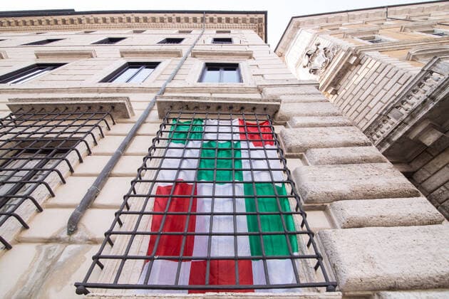 Rome: Italian flag on church in days of COVID-19 Italian flags on the Church of Sant Agnese in Agone and on some balconies in a Piazza Navona without people, on the morning of Sunday 22 March 2020, during the Covid-19 pandemic Roma Italy Copyright: MatteoxNardone
