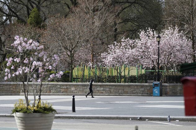 A woman wears a protective face mask while waling in Union Square in New York City on Sunday, March 22, 2020. New York State Gov. Andrew Cuomo said the number of Coronavirus-related deaths in the state is now 114 and of the 15,168 positive cases, 9,045 have been in New York City.  NYP20200322101 JOHNxANGELILLO