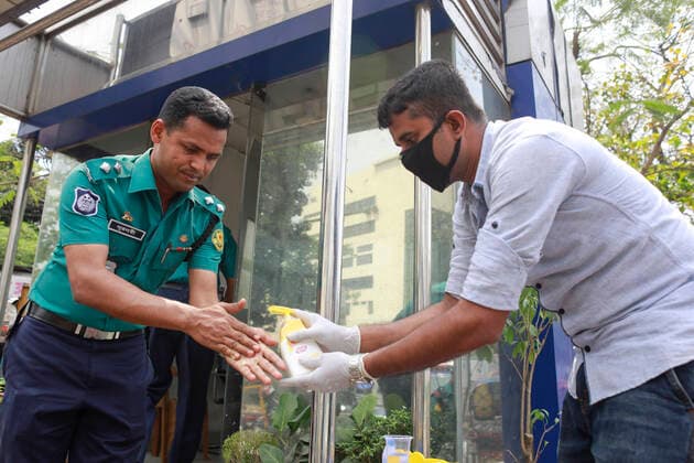 March 22, 2020, Dhaka, Dhaka, Bangladesh: Bangladeshi security officials take precaution during the spread of coronavirus, in Dhaka, Bangladesh, March 22, 2020. 3 more tested positive for COVID-19, raising the number of coronavirus patients to 27 in Bangladesh. The Bangladeshi government has imposed a restriction on all kinds of political, social, cultural and religious gatherings in an effort to contain the further spread of novel coronavirus in the country. Besides, people having fever, cough, influenza or other symptoms of COVID-19 as well as family members of coronavirus-infected patients and those come in contact with the patients have been asked not to go to mosques and other worship places. Dhaka Bangladesh - ZUMAd117 20200322_zap_d117_006 Copyright: xSuvraxKantixDasx