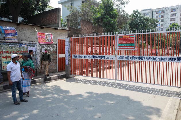 March 22, 2020, Dhaka, Dhaka, Bangladesh: Local administration has kept 672 families of 40 buildings under lockdown in capital s Tolarbag a day after an elderly resident of the area died from coronavirus infection. All entrance gates have been put under lock and no one is allowed to enter or exit from the area. 3 more tested positive for COVID-19, raising the number of coronavirus patients to 27 in Bangladesh. The Bangladeshi government has imposed a restriction on all kinds of political, social, cultural and religious gatherings in an effort to contain the further spread of novel coronavirus in the country. Besides, people having fever, cough, influenza or other symptoms of COVID-19 as well as family members of coronavirus-infected patients and those come in contact with the patients have been asked not to go to mosques and other wor - ZUMAd117 20200322_zap_d117_012 Copyright: xSuvraxKantixDasx