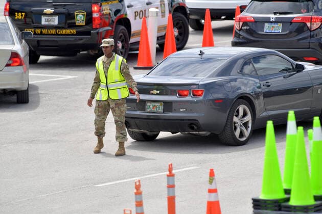 March 23, 2020, Miami Gardens, Florida, United States Of America: MIAMI GARDENS, FL - MARCH 22: FIRST RESPONDERS ONLY TESTING DAY - Instead of setting up for the Miami Open tennis tournament, the Florida National Guard (many without face masks due to shortage) was running a drive-through testing site off the Florida Turnpike at the Hard Rock Stadium in Miami Gardens where people can go for a COVID-19 Test Without Getting out of their Cars. As Miami-Dade Countys number of COVID-19 cases rise to 169, the site will open at 9 a.m. Monday in the east parking lot of the Hard Rock Stadium, 347 Don Shula Drive. The testing is free and the site will be open from 9 a.m. to 5 p.m. on a daily basis, said Juan Diasgranados, a spokesperson for the testing site. The test site will be run and was created by several local, state and national agencies wh - ZUMAs214 20200323_zaa_s214_021 Copyright: xSMGx